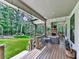 Covered porch boasts an outdoor fireplace, TV, and comfortable seating, perfect for relaxation at 1170 Upper Sweetwater Se Trl, White, GA 30184