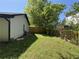 Backyard with lush green grass, a wooden fence, and the side of the home at 5516 Westberry Ln, Norcross, GA 30071