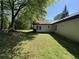 Spacious backyard with grassy area, mature trees and patio at 5516 Westberry Ln, Norcross, GA 30071