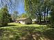 Backyard featuring grass, trees and the side of the home at 5516 Westberry Ln, Norcross, GA 30071