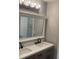 Bathroom featuring double vanity with quartz countertop, modern fixtures and decorative mirror at 5516 Westberry Ln, Norcross, GA 30071