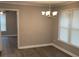 Dining room featuring a chandelier, windows and grey walls over vinyl floors at 5516 Westberry Ln, Norcross, GA 30071