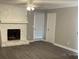 Cozy living room with a white stone fireplace, ceiling fan, and door to the exterior at 5516 Westberry Ln, Norcross, GA 30071