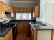 Kitchen featuring wooden cabinets, dark countertops, stainless sink, and a pass-through window at 810 Martin Se St, Atlanta, GA 30315