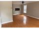 Open living room with hardwood floors, a ceiling fan, and a pass-through window to the kitchen at 810 Martin Se St, Atlanta, GA 30315