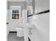 Bright bathroom with tiled walls, pedestal sink, and black and white tiled floor at 948 Sycamore Dr, Decatur, GA 30030