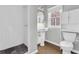 White tiled bathroom features pedestal sink, walk-in shower, and toilet at 948 Sycamore Dr, Decatur, GA 30030