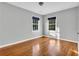 Spacious bedroom with hardwood floors and natural light from two windows at 948 Sycamore Dr, Decatur, GA 30030