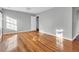 Bedroom with hardwood floors, gray walls, natural light, and white trim at 948 Sycamore Dr, Decatur, GA 30030