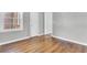 A vacant bedroom offers hardwood floors and neutral grey walls at 948 Sycamore Dr, Decatur, GA 30030
