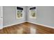 Cozy bedroom featuring hardwood floors and two large windows at 948 Sycamore Dr, Decatur, GA 30030