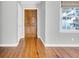 Entryway with hardwood floors, wooden door, gray walls, and large window at 948 Sycamore Dr, Decatur, GA 30030