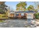 Charming single-story brick home with attached garage and enclosed porch at 948 Sycamore Dr, Decatur, GA 30030