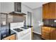 White gas range with sleek stainless steel range hood and black tile backsplash at 948 Sycamore Dr, Decatur, GA 30030