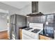 Stainless steel refrigerator, gas range, range hood and granite countertops at 948 Sycamore Dr, Decatur, GA 30030