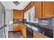Bright kitchen with wooden cabinetry, stainless steel refrigerator and black tile backsplash at 948 Sycamore Dr, Decatur, GA 30030
