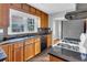 The kitchen is equipped with granite countertops, stainless steel refrigerator and gas range at 948 Sycamore Dr, Decatur, GA 30030
