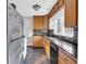 Traditional kitchen features granite countertops, stainless steel refrigerator, and wooden cabinets at 948 Sycamore Dr, Decatur, GA 30030