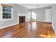 Living room featuring hardwood floors, fireplace, gray walls and many windows at 948 Sycamore Dr, Decatur, GA 30030