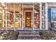 View of brick porch with brick steps, screen windows, and wooden front door at 948 Sycamore Dr, Decatur, GA 30030