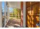 View from porch to yard with wooden front door, brick walls, and screen windows at 948 Sycamore Dr, Decatur, GA 30030