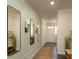 Light-filled entryway with wood floors, decorative mirrors, and a bench at 2641 Cacao Sq, Acworth, GA 30101