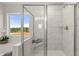 Elegant bathroom showcasing a glass-enclosed shower with a built-in seat and tiled walls at 3790 Near Star Ln, Cumming, GA 30028