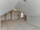 Attic space featuring neutral walls, carpet, unique architecture, and space for storage at 395 Highland Gate Cir, Suwanee, GA 30024