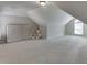 Spacious finished attic space with carpet, window, natural light, and neutral walls at 395 Highland Gate Cir, Suwanee, GA 30024