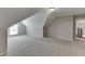 Large finished attic area featuring neutral walls, carpet, and lots of space for activities at 395 Highland Gate Cir, Suwanee, GA 30024