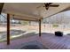 Covered wooden back deck featuring ceiling fan and view of backyard at 395 Highland Gate Cir, Suwanee, GA 30024