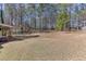 Large backyard with grass and perimeter of tall trees providing privacy at 395 Highland Gate Cir, Suwanee, GA 30024