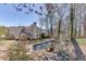 Expansive backyard featuring a beautiful pond and lush greenery at 395 Highland Gate Cir, Suwanee, GA 30024