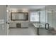 Bright bathroom featuring double vanity, separate glass shower, and soaking tub by the window at 395 Highland Gate Cir, Suwanee, GA 30024