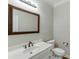 Clean bathroom with a large mirror, white vanity, toilet, and neutral walls at 395 Highland Gate Cir, Suwanee, GA 30024
