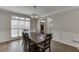 Bright dining area with wood floors, wainscoting, and a large window at 395 Highland Gate Cir, Suwanee, GA 30024
