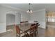 Dining room with modern lighting, wood flooring, and decorative trim at 395 Highland Gate Cir, Suwanee, GA 30024