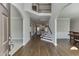 Inviting foyer with hardwood floors, archways, staircase, and views of the living room and dining area at 395 Highland Gate Cir, Suwanee, GA 30024