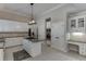 Stylish kitchen equipped with stainless appliances, granite counters, a central island, and elegant white cabinetry at 395 Highland Gate Cir, Suwanee, GA 30024