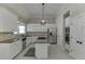 Spacious kitchen featuring stainless steel appliances, granite countertops, white cabinetry, and a functional island cooktop at 395 Highland Gate Cir, Suwanee, GA 30024
