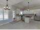 Bright kitchen with white cabinetry, stainless steel appliances, granite countertops and large island with cooktop at 395 Highland Gate Cir, Suwanee, GA 30024