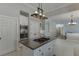 Open-concept kitchen features granite island with cooktop, built-in appliances, and opens to additional living spaces at 395 Highland Gate Cir, Suwanee, GA 30024