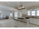 Modern kitchen featuring stainless appliances, island cooktop, stone counters and a seamless connection to living spaces at 395 Highland Gate Cir, Suwanee, GA 30024