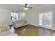 Spacious living room with hardwood floors, crown molding, neutral walls, and a view of the staircase at 395 Highland Gate Cir, Suwanee, GA 30024
