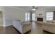 Inviting living room featuring hardwood floors, a brick fireplace, and natural light from large windows at 395 Highland Gate Cir, Suwanee, GA 30024