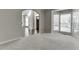 Spacious living room featuring neutral paint, large windows, and an open view into the entry hallway at 395 Highland Gate Cir, Suwanee, GA 30024