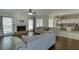 Open concept living room featuring hardwood floors, a fireplace, and seamless transition to the kitchen at 395 Highland Gate Cir, Suwanee, GA 30024