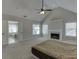 Spacious main bedroom with vaulted ceiling, fireplace, and adjoining bathroom with tub at 395 Highland Gate Cir, Suwanee, GA 30024