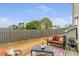 Backyard patio with seating and a small table, bordered by a wooden fence and a lawn at 4037 Hill Station Ct, Sugar Hill, GA 30518