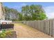 Fenced backyard with green perimeter and a patio with outdoor seating, perfect for entertaining at 4037 Hill Station Ct, Sugar Hill, GA 30518